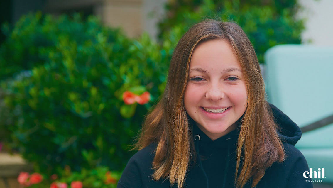 Aspen on a green background smiling
